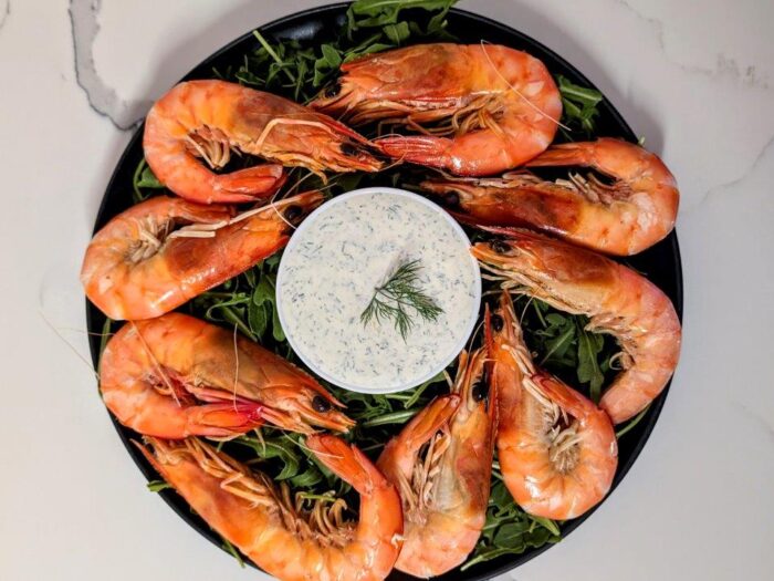 Smooth and creamy dill sauce, served in the middle of whole king prawns atop a bed of rocket