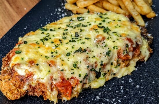 A crispy chicken schnitzel topped with lashings of napoli sauce and melted cheese