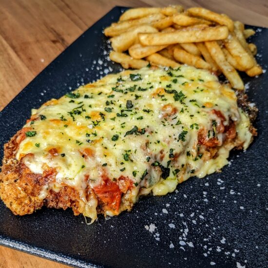 A crispy chicken schnitzel topped with lashings of napoli sauce and melted cheese