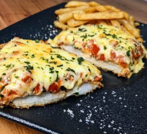 A crispy chicken schnitzel topped with lashings of napoli sauce and melted cheese