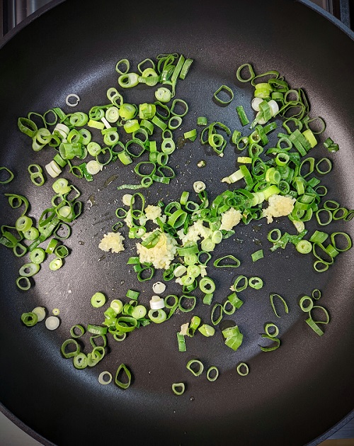 Chopped spring onions and minced garlic sauteed until softened